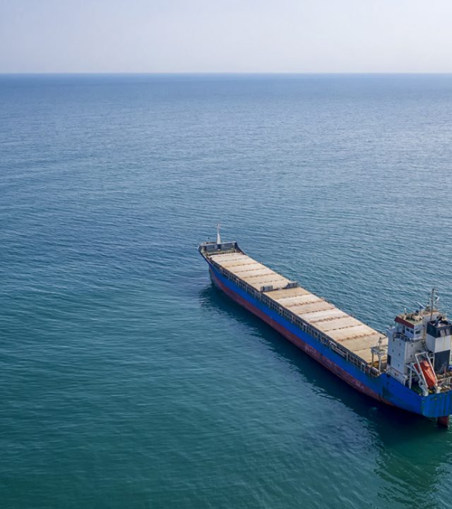 Big empty ship at sea. Aerial top view of cargo ship vessel import-export sailing.